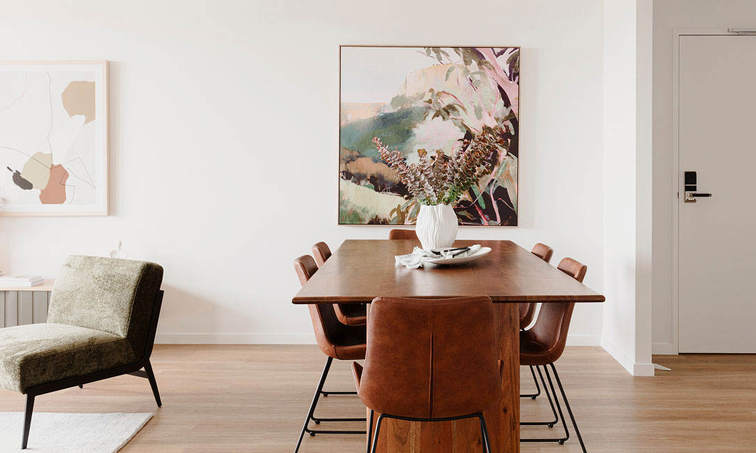 Open-plan living at Dickson Village with high ceilings, natural light and a generous balcony