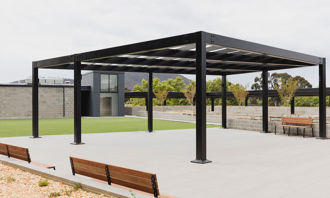 Landscaped rooftop terrace at Dickson Village with BBQ zones and outdoor seating