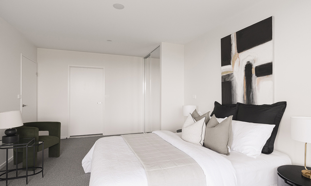 Master bedroom at G+ with generous glazing and private balcony