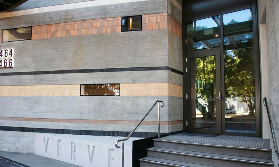 Verve night facade with architectural lighting and skyline presence