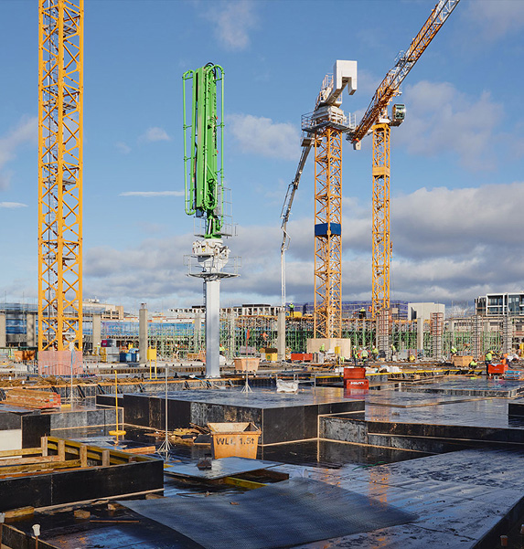 Construction progress at Dickson Village redevelopment site with cranes and foundations
