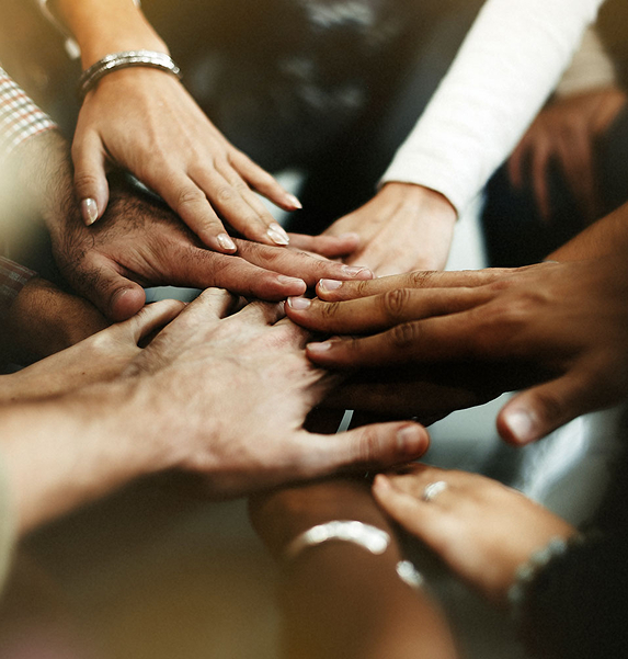 Hands of diverse family members joined together in unity