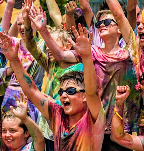 Students celebrating at the Franklin Primary colour run covered in bright powder