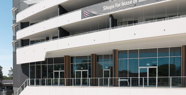 Exterior of G+ Retail commercial precinct in Giralang with modern glass-fronted shopfronts by TP Dynamics