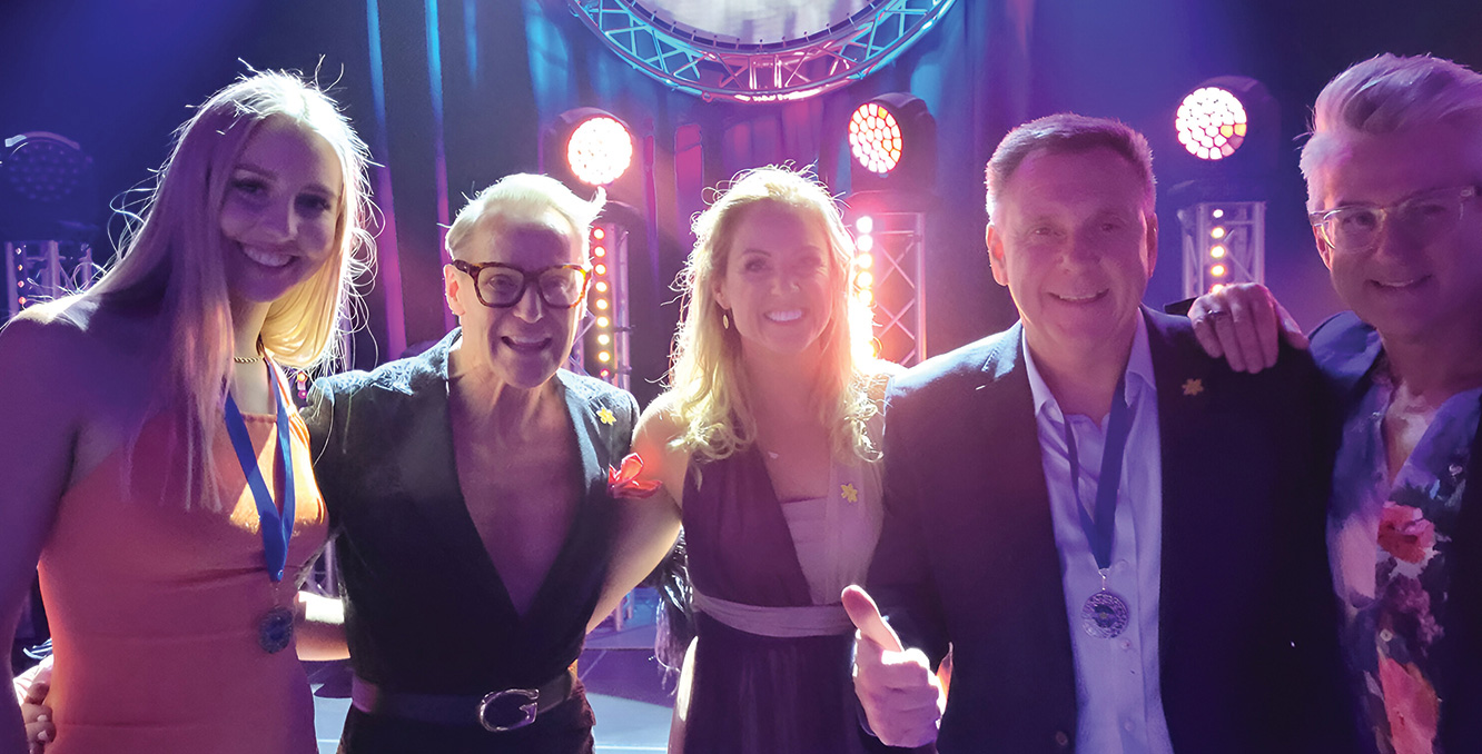 Dancers and Cancer Council Stars event hosts celebrating together on stage