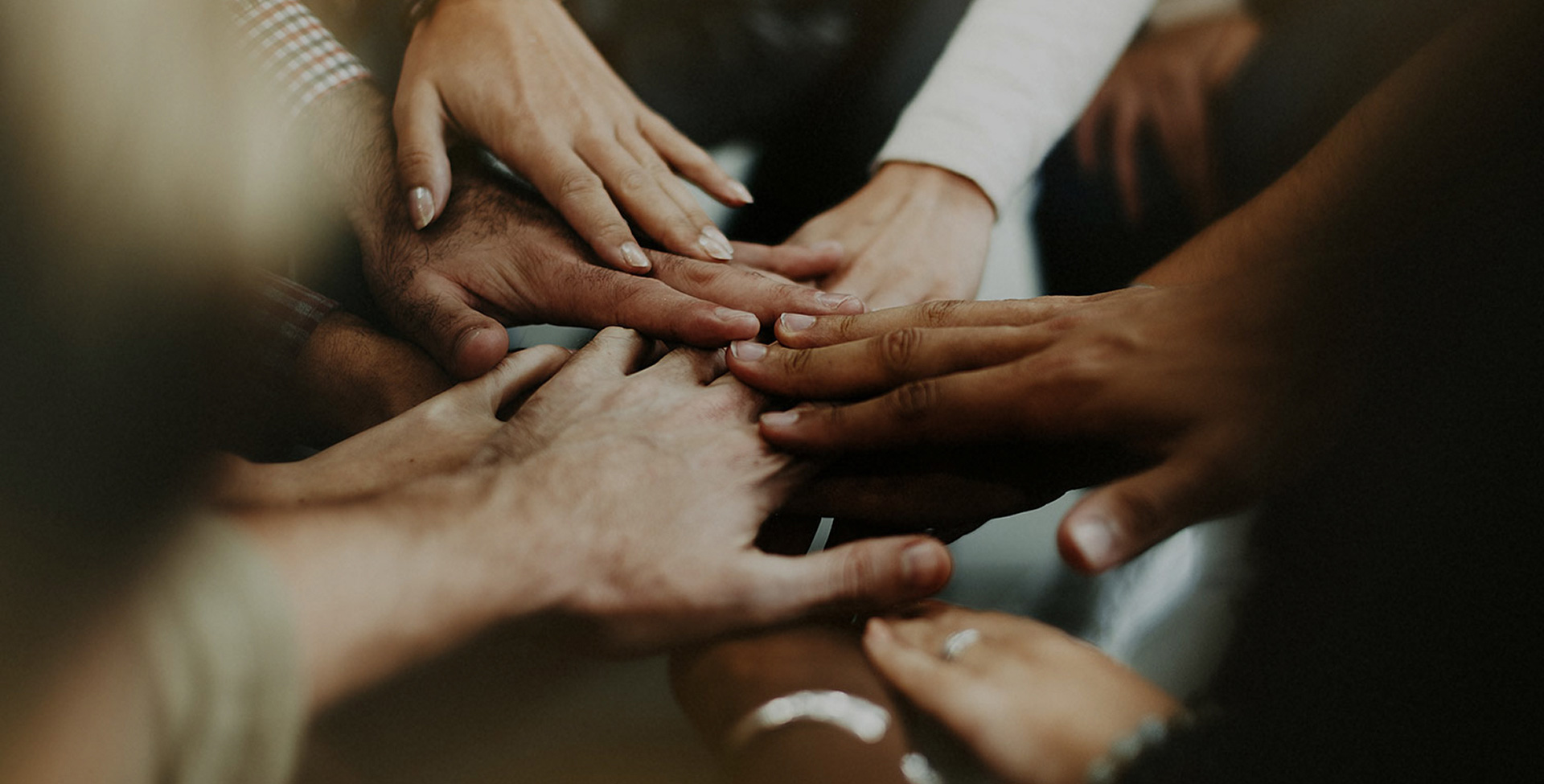 Hands of diverse family members joined together in unity