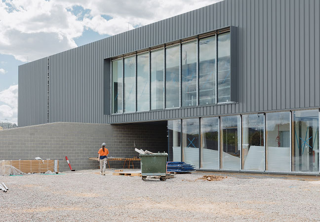 Exterior of the future Yowani Country Golf Clubhouse showing new roof, glass façade and completed structural framework