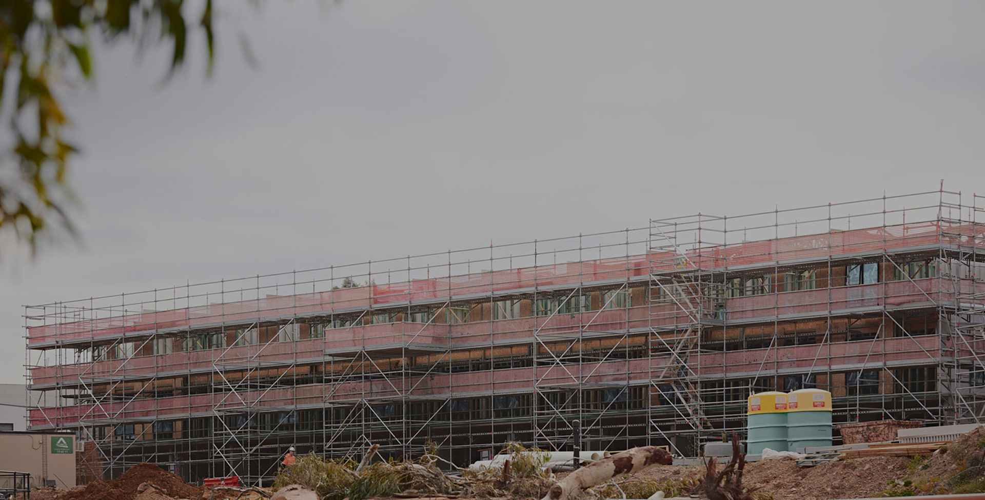 Construction progress on multi-storey residential building with scaffolding