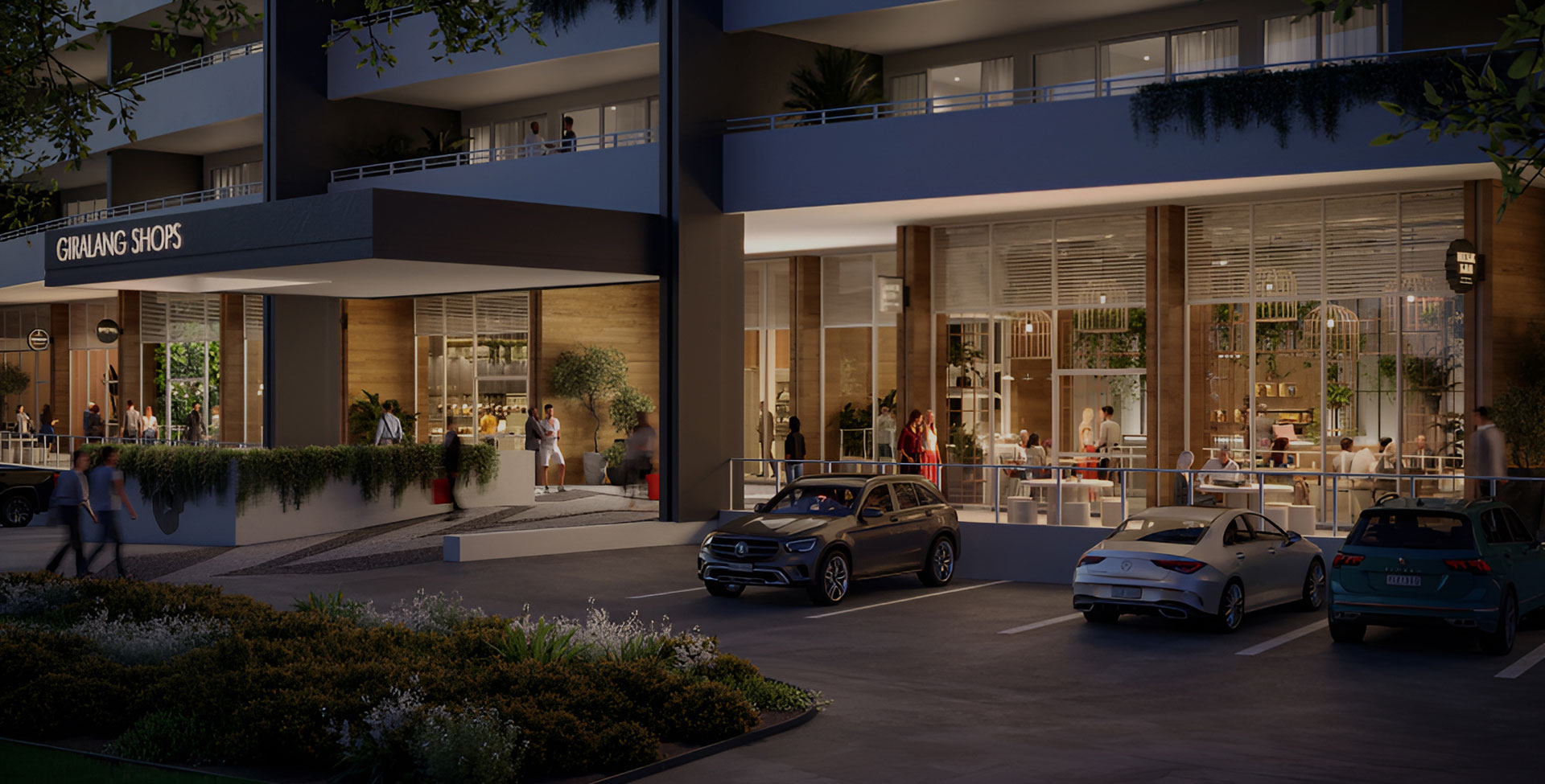 Street-level view of G+ Giralang with activated retail and dining at dusk