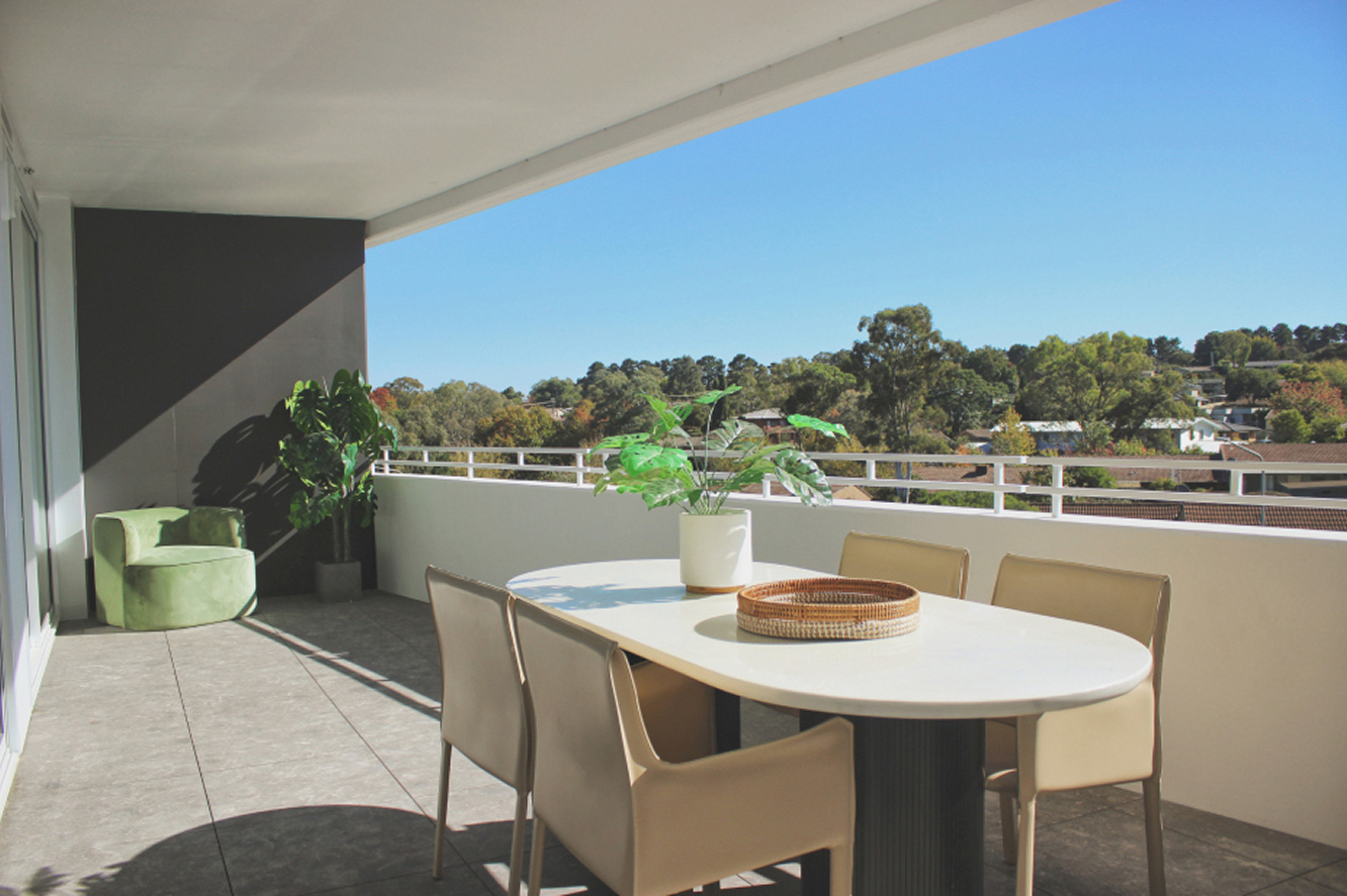 Spacious G+ at Giralang apartment balcony with outdoor dining and district views