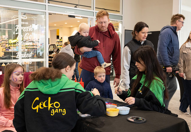 Residents gathering outside the Giralang Shops during the vibrant retail launch event