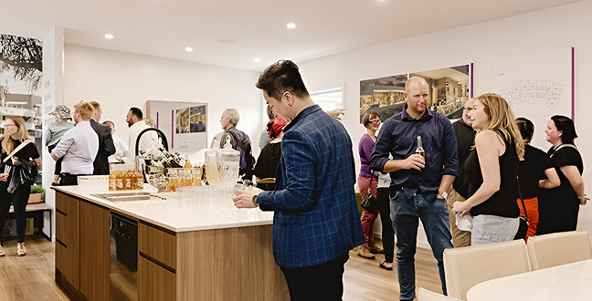 Guests networking inside the Giralang display suite during the launch
