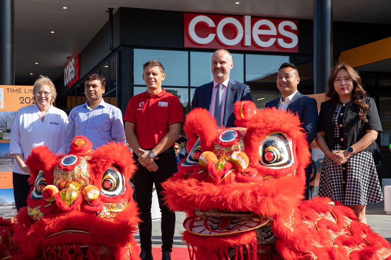Officials and lion dancers at the grand opening of Coles in Dickson Village