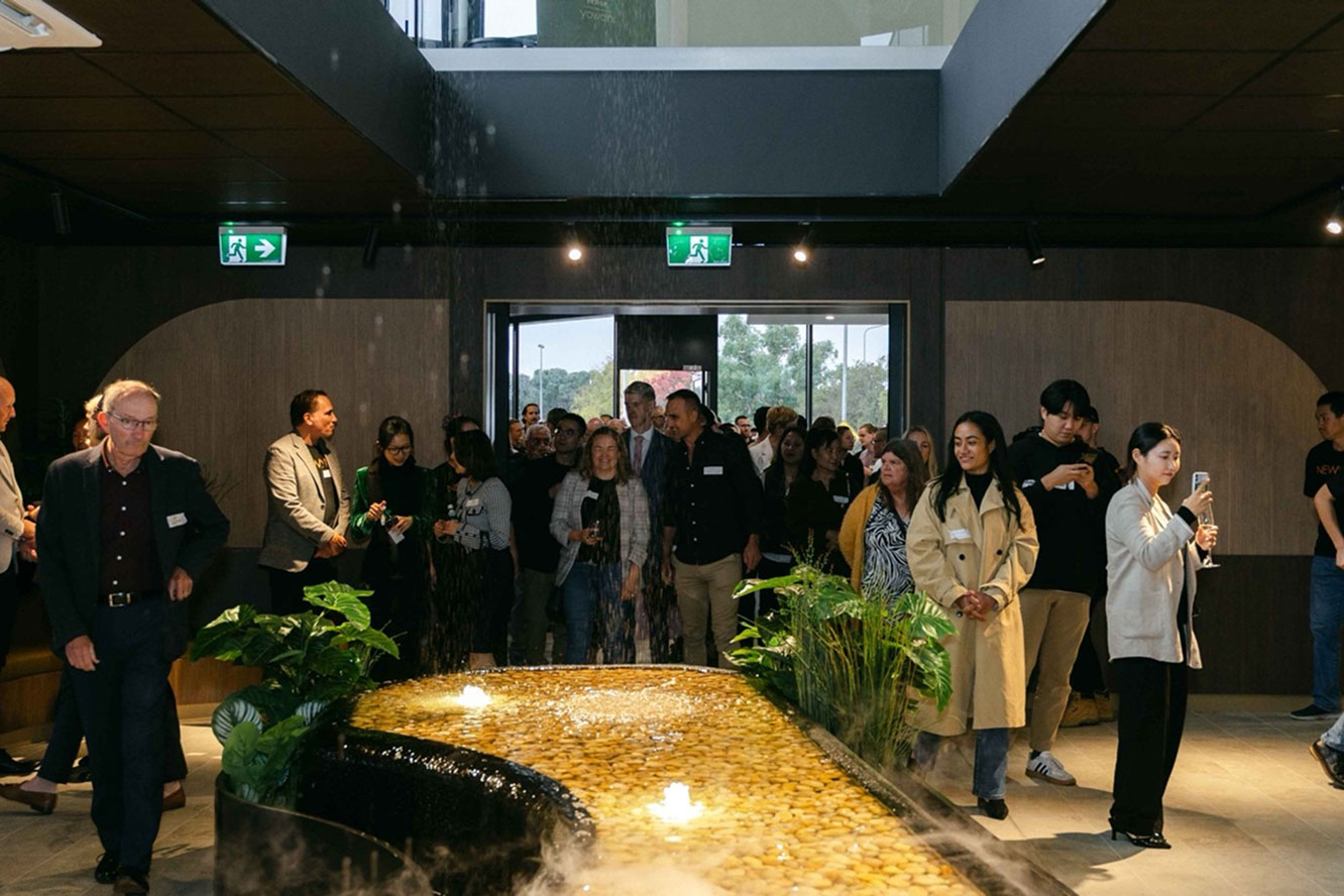 Visitors exploring the interior of Newlyne Experience Centre with water feature and display areas