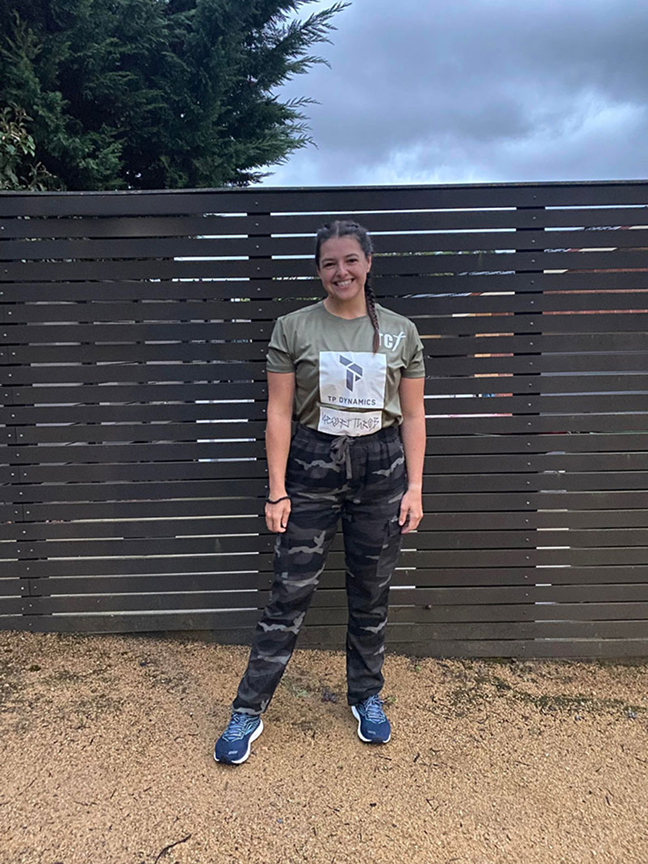 Nicole Bell standing in TP Dynamics sponsorship uniform