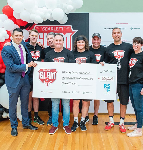 Scarlett Slam participants presenting a $100,000 cheque to the Ricky Stuart Foundation