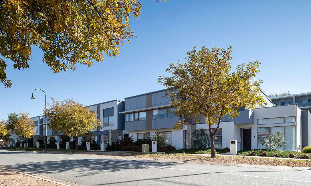 TP Dynamics Amaroo townhouses in Canberra on a tree-lined street, contemporary villas designed for family living