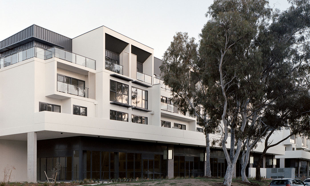 IVES by TP Dynamics – corner façade with balconies and mature trees, Bruce, Canberra, Australia.