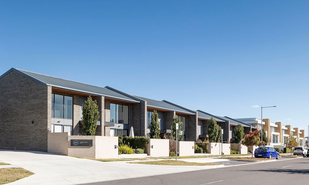Upper-level balconies and black-framed windows at Nest I in Lawson, Canberra