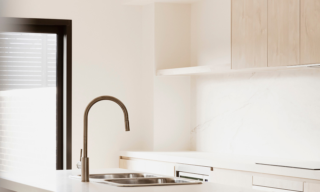 RISE kitchen with SMEG appliances, stone benchtops and porcelain splashback — generous storage by TP Dynamics