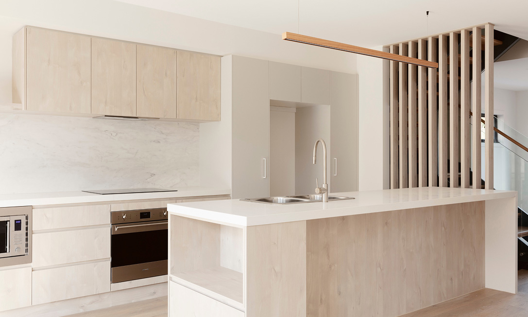 Open-plan living at RISE townhouses — high ceilings, natural light and calm modern interiors in Bruce, Canberra