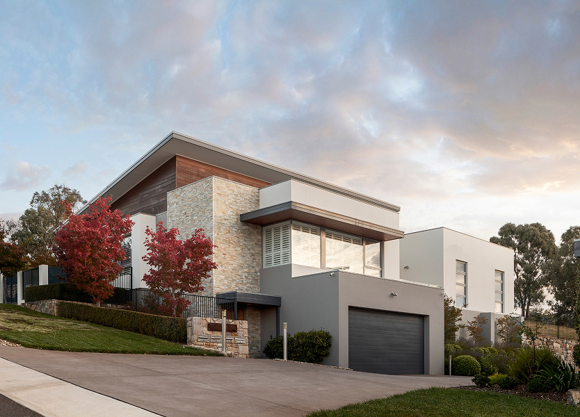 Hillcrest contemporary hillside homes in Weston with floating upper level and natural stone, glass and timber detailing
